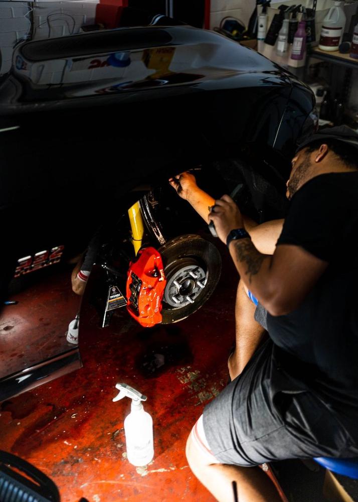 Obsidian detailer servicing an engine bay in the Towson studio