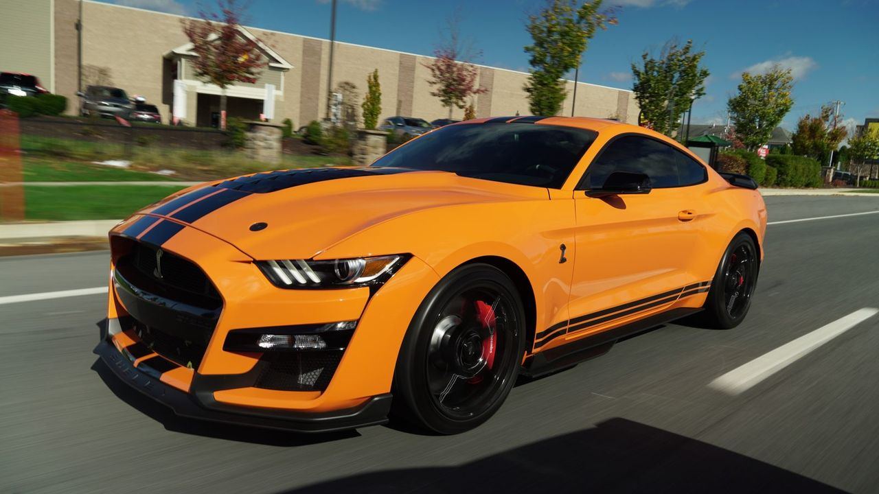 Orange Shelby GT500 with a swirl-free, mirror-gloss finish after mobile paint correction in Baltimore